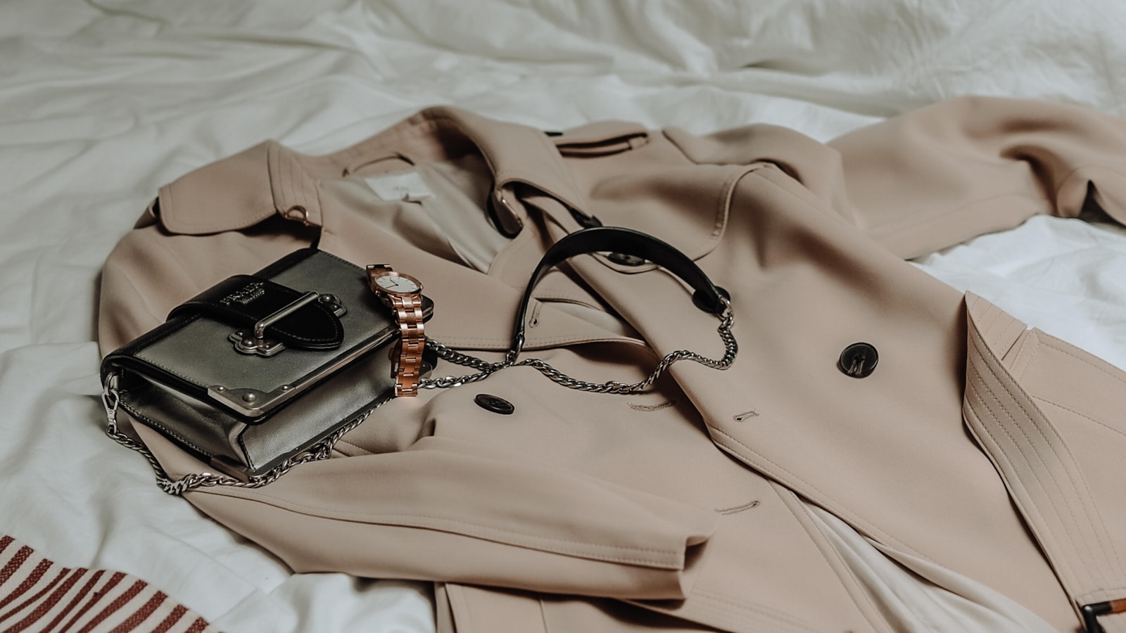 a neutral capsule wardrobe arranged on a clothing rack